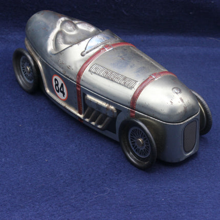 Vintage toy race car with number 84 on a blue background