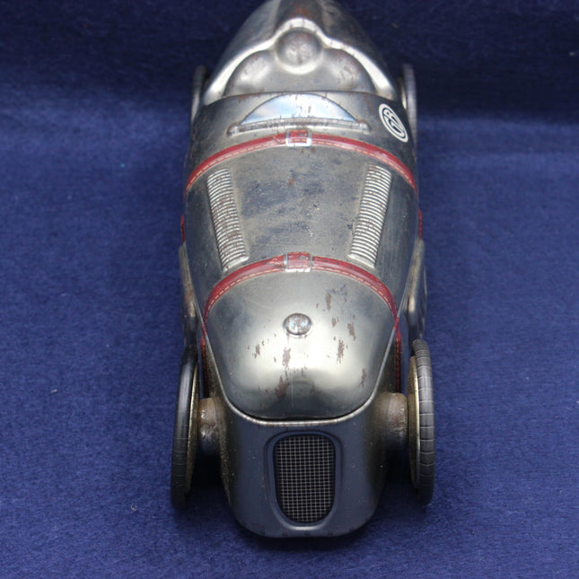 Vintage toy car with a metallic finish on a blue background