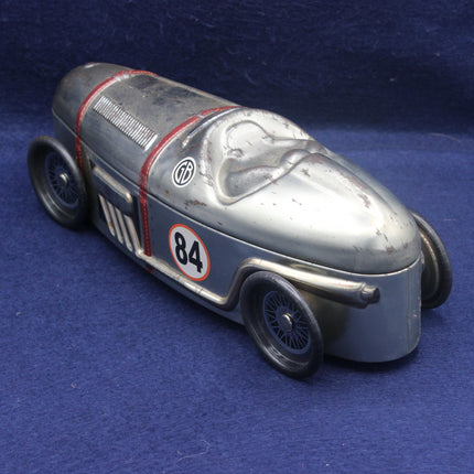 Vintage toy race car with number 84 on a blue background