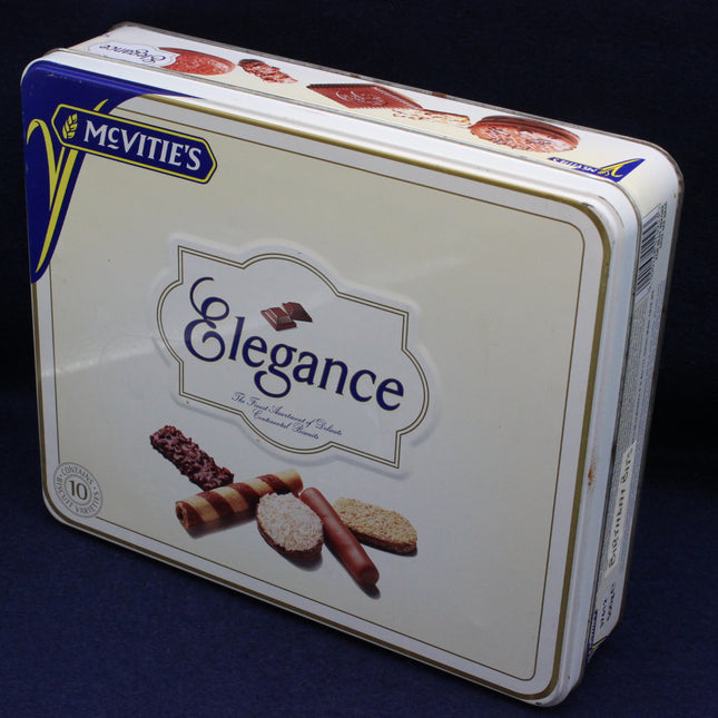 Mcvitie's Elegance cookie tin on a dark background