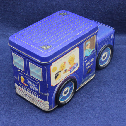 Blue toy bus-shaped container with graphics on a blue background