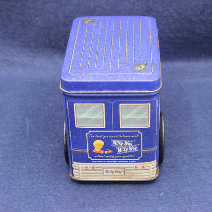 Blue toy bus with a Milky Way candy advertisement on a blue background