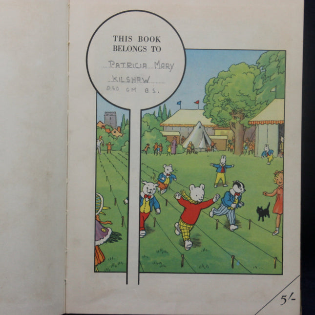 Illustrated book cover with children playing at a fair, featuring text 'This book belongs to Patricia Mary Kilshaw'.