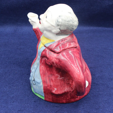 Vintage ceramic figurine of a child in a red outfit on a blue background