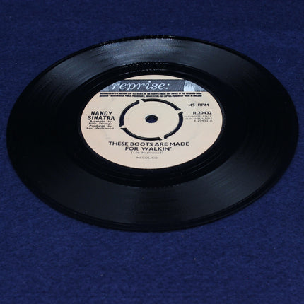 Vinyl record Nancy Sinatra – These Boots Are Made For Walkin with a blue background