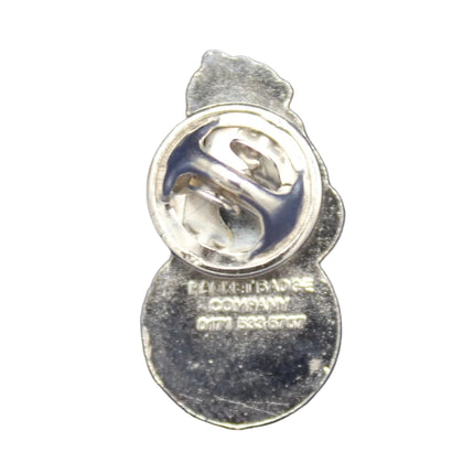 Small gold badge with a logo on a dark blue textured background