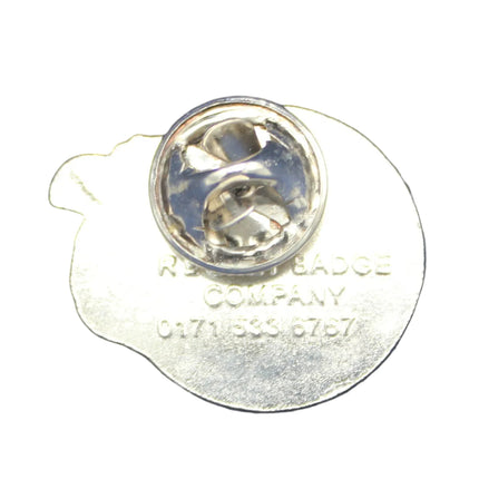 Silver lapel pin on a blue fabric background