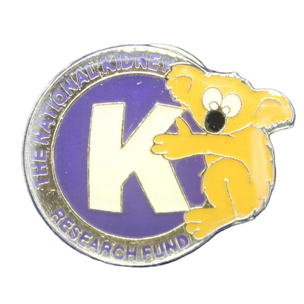 Pin with a logo featuring a 'K' on a blue textured background
