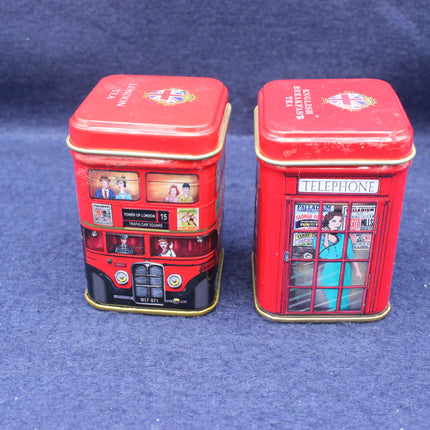 Two red tins with London-themed designs on a blue background