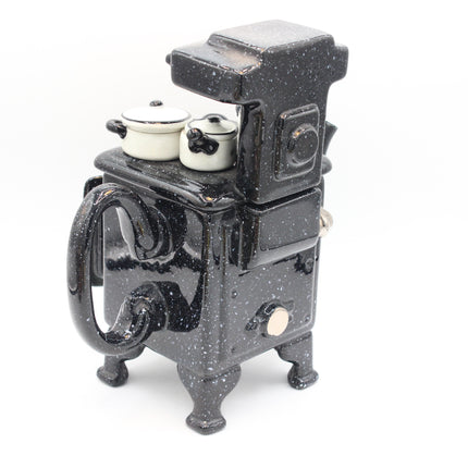 Paul Cardew Design Large Country Kitchen Stove Teapot black speckled ceramic stove and oven toy with two small white pots on top, photographed on a clean white background.