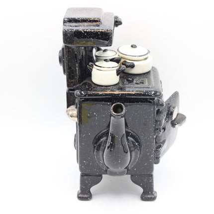 Paul Cardew Design Large Country Kitchen Stove Teapot stove with two small cream-colored pans on top, photographed against a plain white background.
