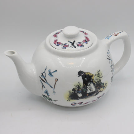 A white ceramic teapot with a lid, decorated with colorful illustrations of gardening tools and a scene of a person gardening, set against a plain light gray background.