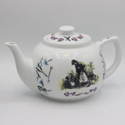 A white ceramic teapot decorated with colorful illustrations of historical figures and tools, photographed against a neutral light gray background.