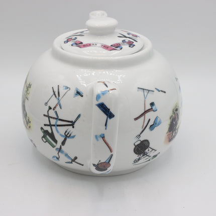 A white ceramic teapot decorated with various hand-painted gardening tools and motifs on a clean white background.