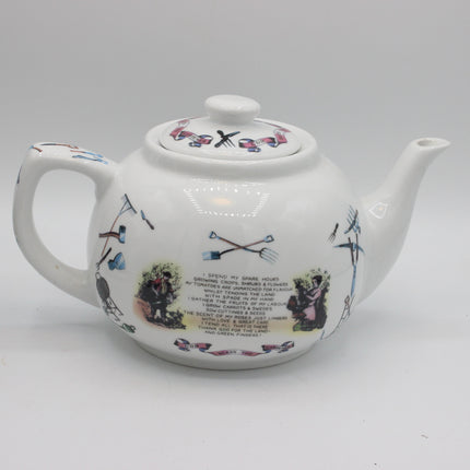 A white ceramic teapot with hand-painted illustrations of garden tools, a small illustrated scene, and a printed poem on the front, set against a plain light gray background.