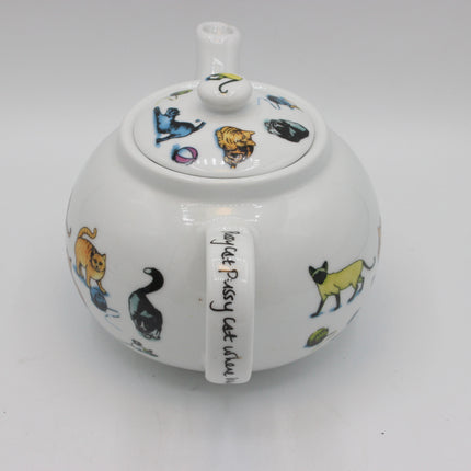 A white ceramic teapot decorated with colorful cat illustrations and the text 'lady Pussy cat always' on the handle, shown on a plain white background.