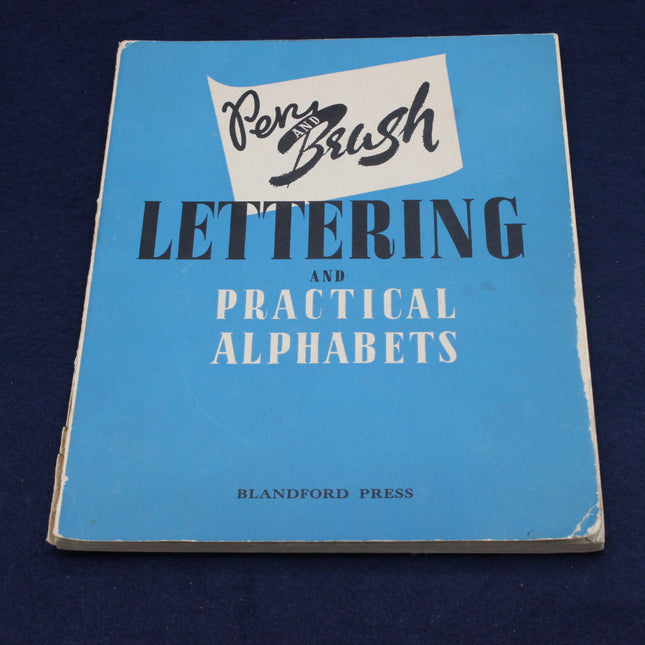 Book titled 'Lettering and Practical Alphabets' by Blandford Press on a blue background