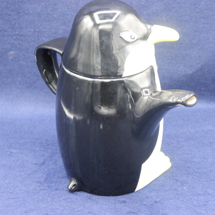 Penguin-shaped teapot on a blue background