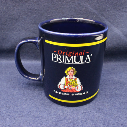 Navy blue mug with 'Original Primula Cheese Spread' branding on a gray background