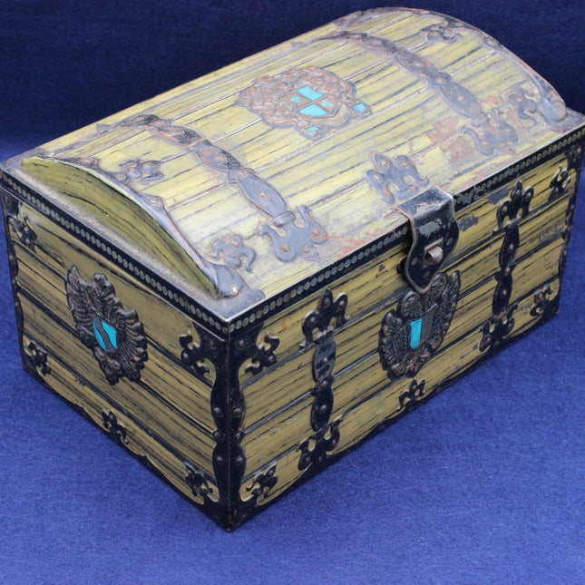 Decorative wooden box with intricate designs on a blue background