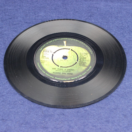 Vinyl record with a green label on a blue surface