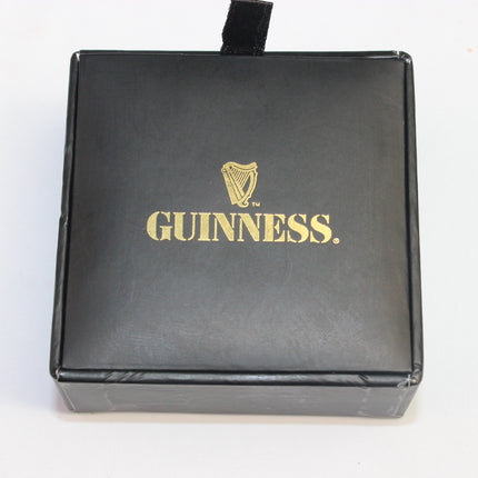 Black box with gold Guinness logo on a white background