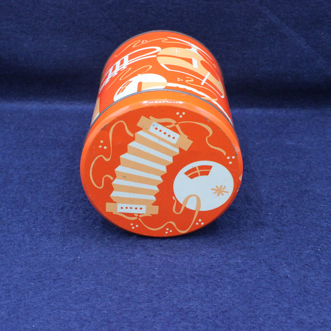 Orange cylindrical tin with decorative design on a blue background