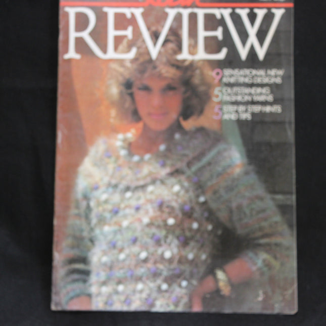 Magazine cover featuring a woman wearing a beaded sweater with 'REVIEW' at the top.