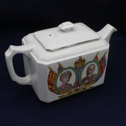 White teapot with royal portraits and flags on a dark background