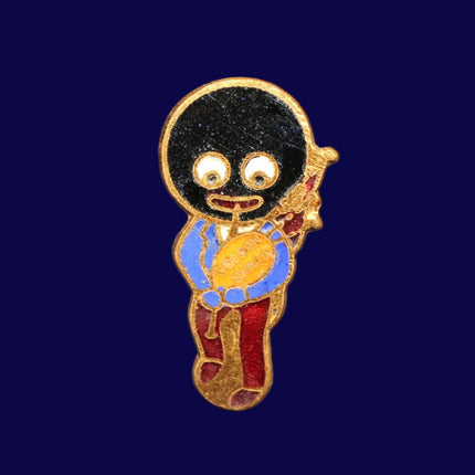 Golly bagpiper pin badge on a dark blue background