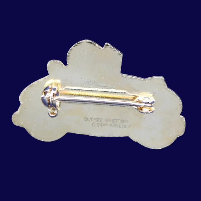 Decorative Golly brooch on a blue textured background with Robertson's backstamp
