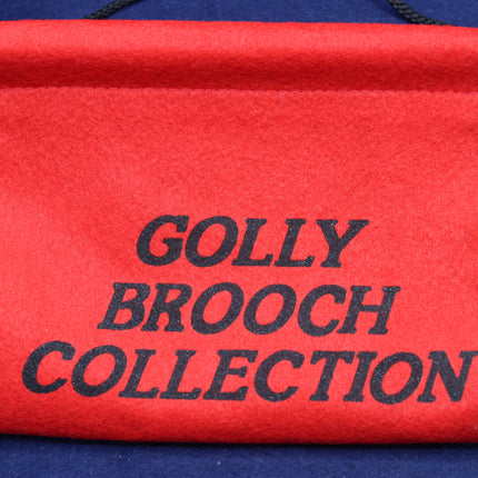 Red scroll with 'Golly Brooch Collection' text on a blue background