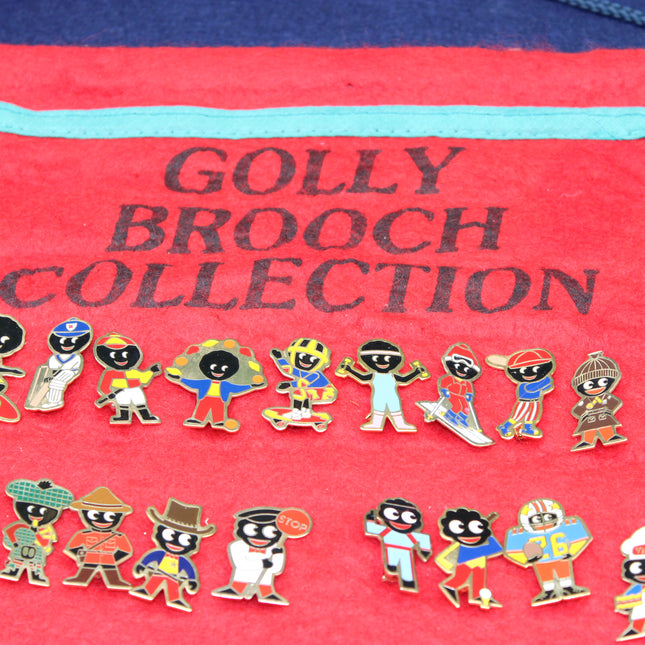A collection of colorful enamel pins shaped like cartoon characters, displayed on a red fabric pouch printed with the text 'GOLLY BROOCH COLLECTION'.