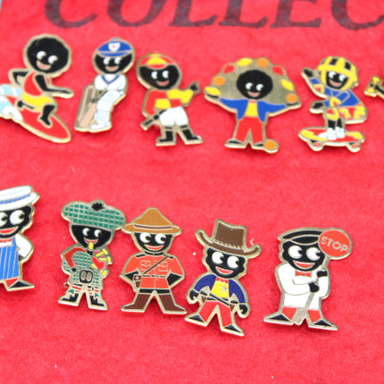 A set of colorful enamel Robertson's Golly lapel badge pins, arranged on a textured red background.