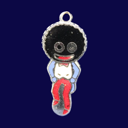 Golliwog charm on a textured blue background