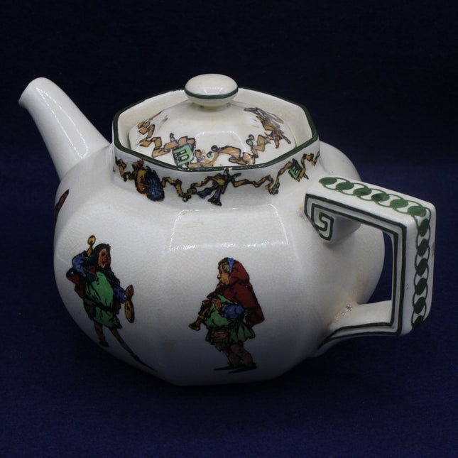 White teapot with colorful decorative elements on a dark background