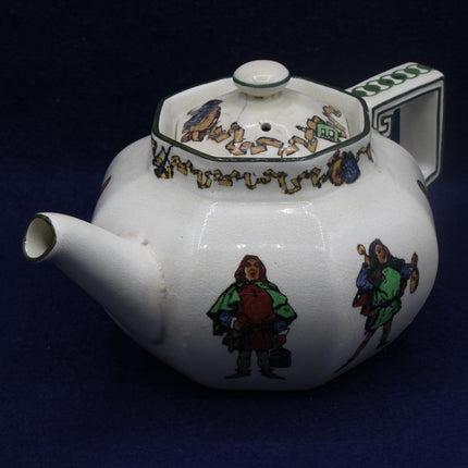 Decorative teapot with colorful figures on a dark background