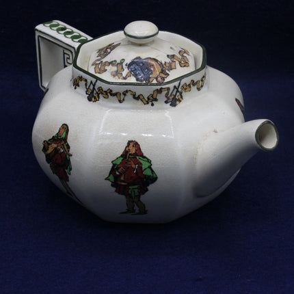 Decorative teapot with colorful figures on a dark background