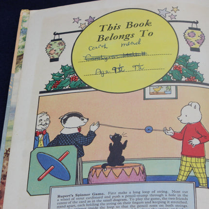 Vintage children's book page with cartoon characters and 'This Book Belongs To' label.