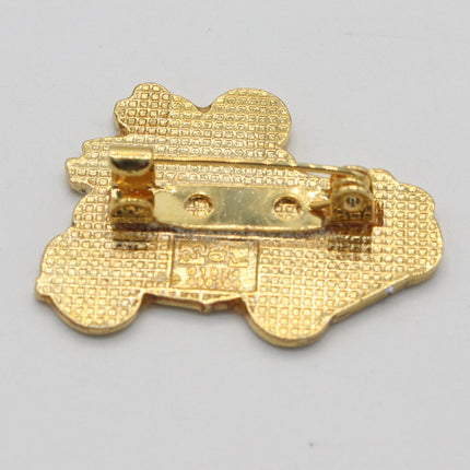 Gold-colored textured enamel pin with a butterfly design and a metal pin clasp, shown on a plain light gray background.
