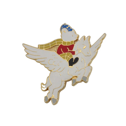An enamel pin depicting a white Pegasus with gold trim, ridden by a white Rupert bear wearing a red shirt, yellow scarf, and blue hat, set against a plain white background.