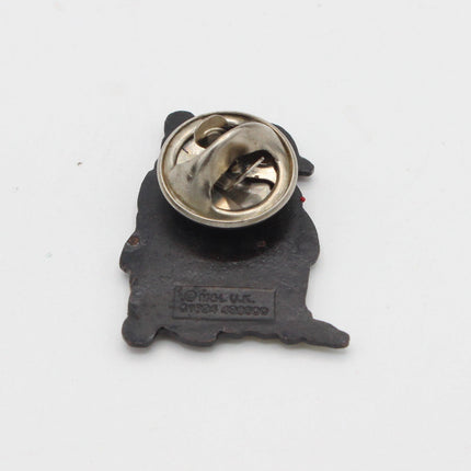 A small black enamel lapel pin shaped like a dog silhouette, showing the metal clutch backing with a silver-tone pin on a plain white background.