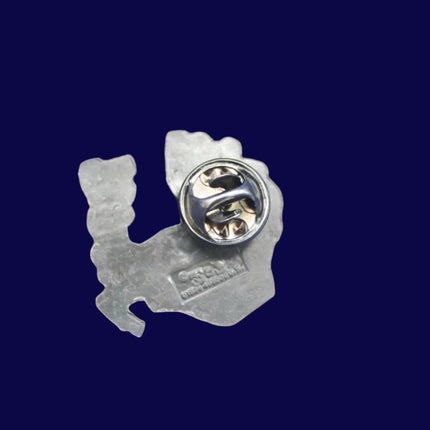 Metallic Rupert Bear pin with a unique design on a blue textured background