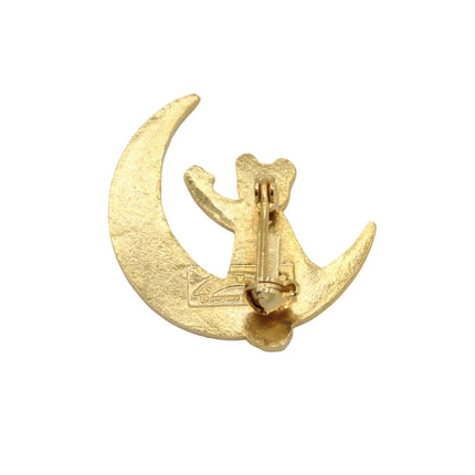 A small gold crescent moon and rupert bear pin shown from the back on a plain light gray background.