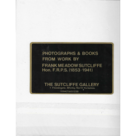 Plaque with text about photographs and books by Frank Meadow Sutcliffe, displayed on a white background.