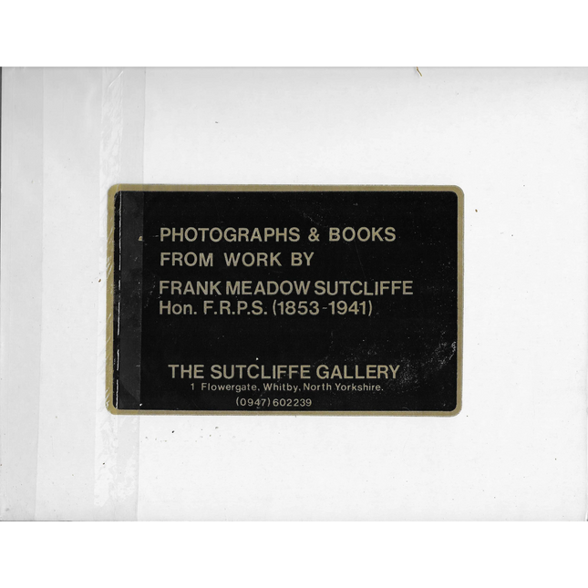 Plaque with text about photographs and books from Frank Meadow Sutcliffe, displayed on a white background.