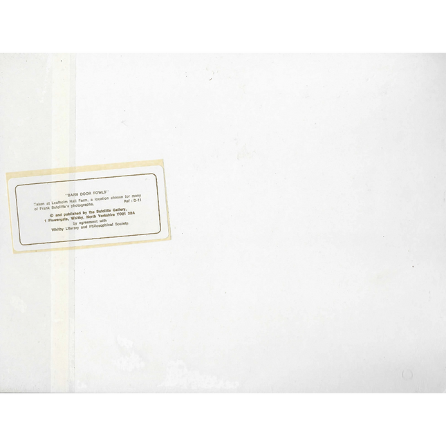 White paper with a small yellow label containing Sutcliffe Gallery text on a white background