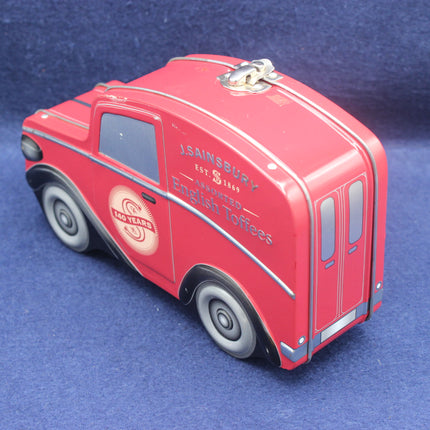 Red model of a vintage delivery van with 'Sainsbury's' branding on a blue background
