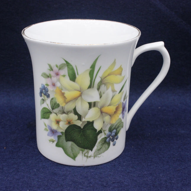 White mug with floral design on a dark blue background