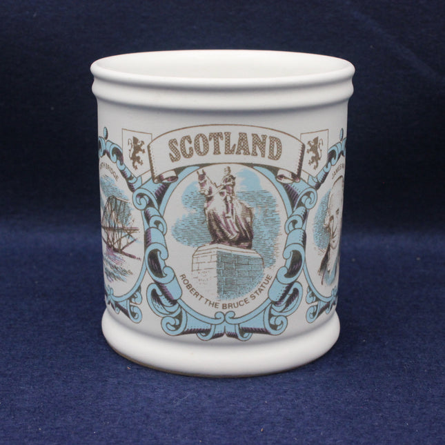 Ceramic mug with decorative design and 'Scotland' text on a blue background